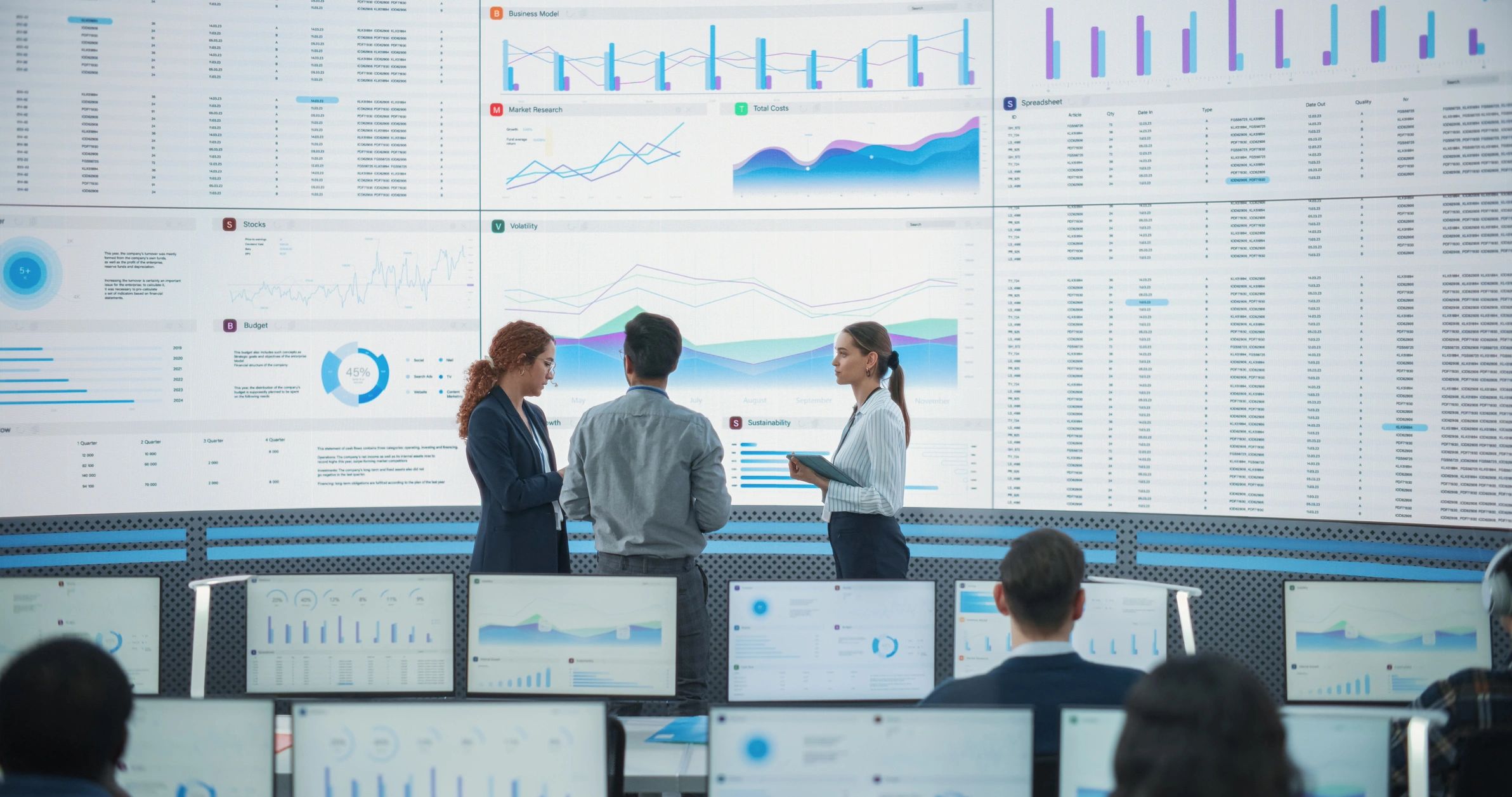 Team reviewing analytics on a large screen in a monitoring room
