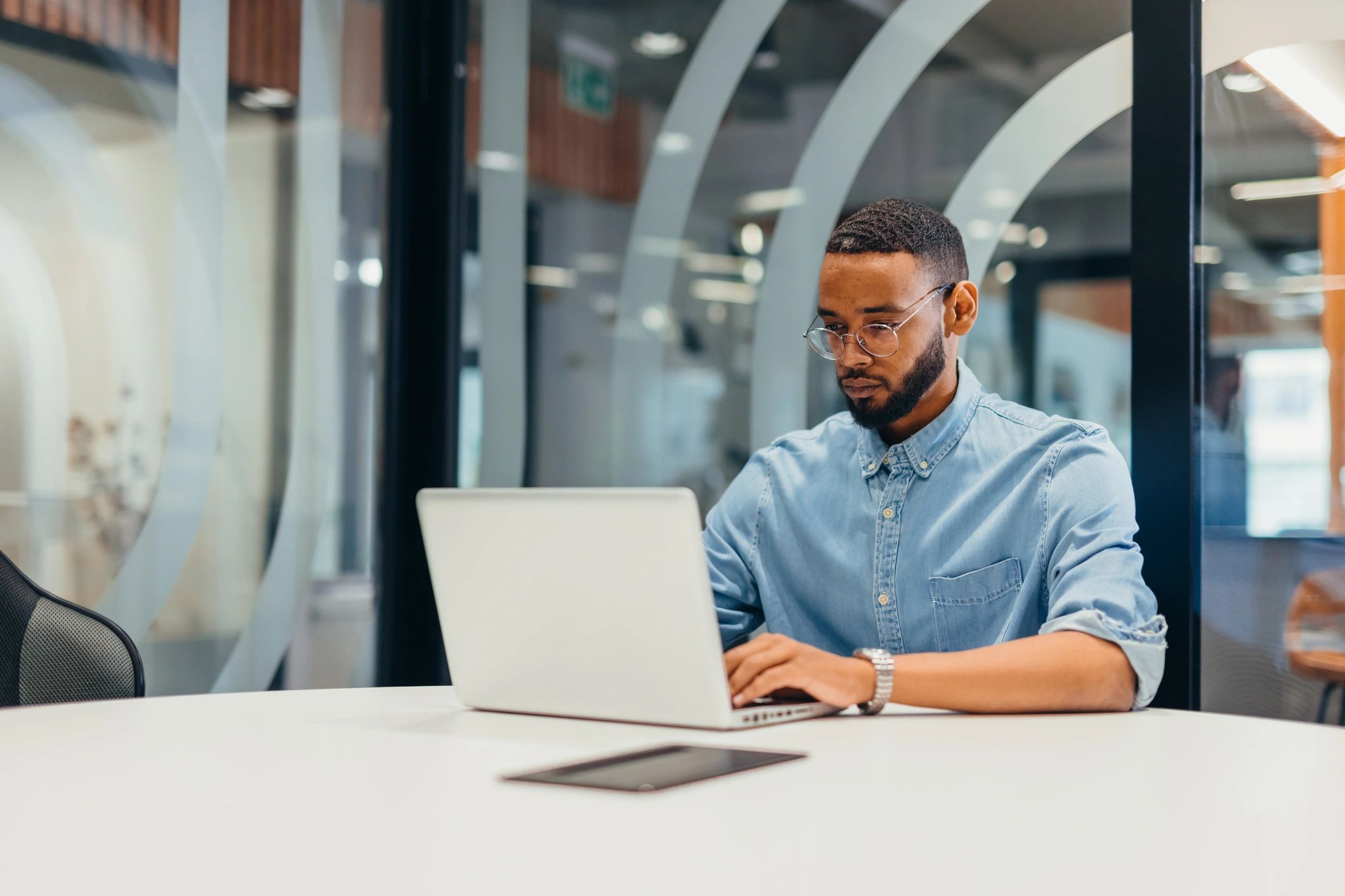 Professional working on a laptop in a modern office